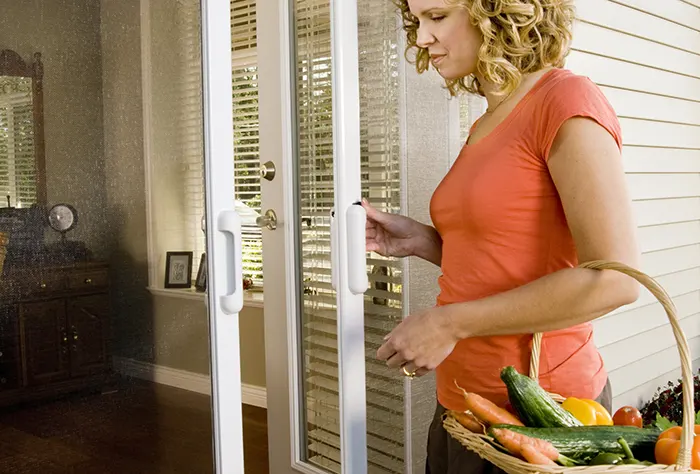 Woman with basket of vegetables at screen door